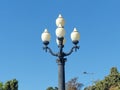 Old streetlight among the greenery. Walking around the city. Royalty Free Stock Photo