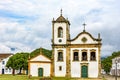 Old streets with historic church facade and houses in colonial architecture Royalty Free Stock Photo