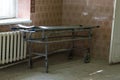 Old stretcher gurney bed in the hospital hallway. A horrible old hospital or morgue