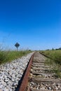 An old stripe with a sign on the side that says 100, with a blue sky in the background Royalty Free Stock Photo