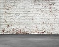 Old stripped bricks wall with dirty concrete floor Royalty Free Stock Photo