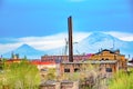 Old structures and factory buildings against the backdrop of Mount Ararat.