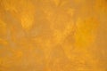 Old stucco plaster yellow painted wall abstract background texture