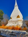 Old stupa with flower offerings, Loei, Thailand