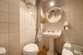 Old-style bathroom with white tiles, vintage porcelain sinks, and a small bathtub Royalty Free Stock Photo