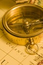 Old style brass compass on a map Royalty Free Stock Photo