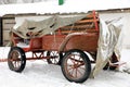 Old style cart under snowfall