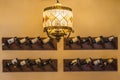 Old-style chandelier on the background of a wall with wine bottles in the interior of a cafe