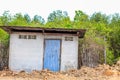 Old style cottage with old blue door on the field Royalty Free Stock Photo