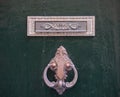 An old style decorative bronze door handle on a wooden door, the distinctive feature and symbol of Malta in Mdina. Royalty Free Stock Photo