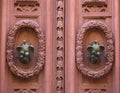 An old style decorative bronze door handle on a wooden door, the distinctive feature and symbol of Malta in Mdina.