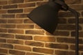 Old style desk lamp on a background of brick wall Royalty Free Stock Photo