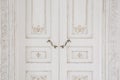 Old-style door, white - handle closeup. antiques interior