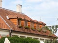 old style dormer windows with terracotta tiles
