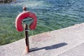 Old style foam buoy life water safety ring at sea dock port