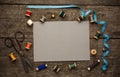 An old style image of cotton reels and other sewing items on a wooden table. Image has been aged to give a retro or Royalty Free Stock Photo