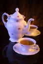 Old-style kettle with two cups of tea on black Royalty Free Stock Photo