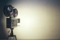 Old style movie camera with white wall, vintage photo effect Royalty Free Stock Photo