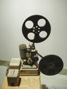 Old style movie projector, still-life, close-up. vintage, old-fashioned film projector, blurred background Royalty Free Stock Photo