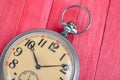 Old style pocket watch on red wooden backround Royalty Free Stock Photo