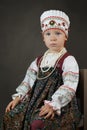 Old style portrait of the little girl in the traditional russian shirt, sarafan and kokoshnik Royalty Free Stock Photo