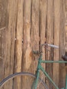 Old style rusty green bicycle and wooden wall Royalty Free Stock Photo