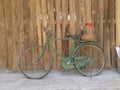 Old style rusty green bicycle and wooden wall Royalty Free Stock Photo