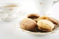 Old-style shot kettle with cup of tea with cookies foreground on Royalty Free Stock Photo