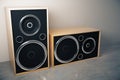 Old style stereo speakers on concrete floor