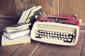 Old style typewriter with books on wooden floor Royalty Free Stock Photo