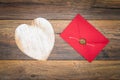 Retro classic Valentine`s Day cad, large white painted wooden hart, isolated, red envelope with wax seal, on vintage oak panels - Royalty Free Stock Photo