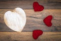 Retro classic Valentine`s Day cad, large white painted wooden hart, isolated, 3 red cuddle harts, on vintage oak panels - top view Royalty Free Stock Photo