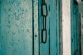 An old style wooden door with a hanging chain as doorknob Royalty Free Stock Photo