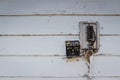 Old style  wooden wall background. electrical couplers Wires and terminals  Painted  white and cracked. Royalty Free Stock Photo