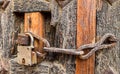 Old styled rusty chain door lock on the wooden door Royalty Free Stock Photo