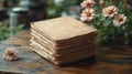 Old styled stacked papers with pink flowers on a rustic table background Royalty Free Stock Photo