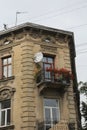 An old, stylish tenement house with decorations and ornaments and stylish balconies with flowers