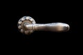 Old stylized door bronze handle on a black isolated background