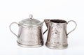 Old sugar bowl with lid and an old coffee pot with spots of rust Royalty Free Stock Photo