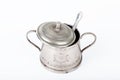 Old sugar bowl with lid and spoon with spots of rust on a white Royalty Free Stock Photo