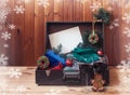 Old suitcase with christmas presents, gingerbreads cookie in shape of christmas wreath, red wine and gingerbread man.