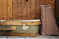 An old suitcase of green and yellow leather put on the ground Royalty Free Stock Photo