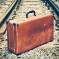 Old suitcase on the railway