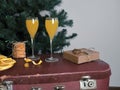 On an old suitcase there are glasses containing a Mimosa cocktail with champagne and orange juice Royalty Free Stock Photo