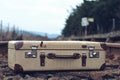 Old suitcase at the train station with retro effect Royalty Free Stock Photo