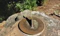 An old sundial is set on the stone.