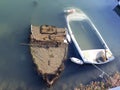 Old sunken boats at the shore of the old pier in Bari