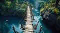 Old suspension bridge across river in jungle, perspective view of hanging vintage wooden footbridge. Scenery of tropical forest Royalty Free Stock Photo