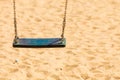 Old swing made of wood on sandy beach Royalty Free Stock Photo