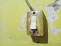 Old switch on yellow wall Royalty Free Stock Photo